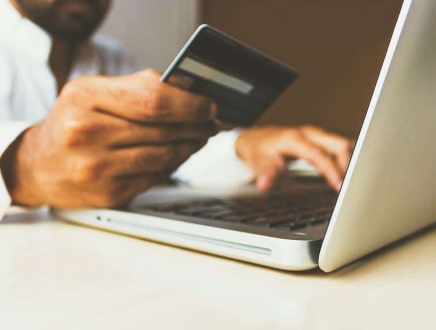 A customer paying online with a card and a laptop
